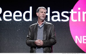 Reed Hastings says Netflix is "reluctantly" paying for faster connections to broadband networks.