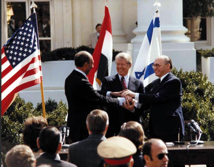 Egyptian President Anwar Sadat, President Jimmy Carter, and Israeli Prime Minister Menachem Begin celebrate the signing of a peace treaty on March 26, 1979. (Photo: Jimmy Carter Library)