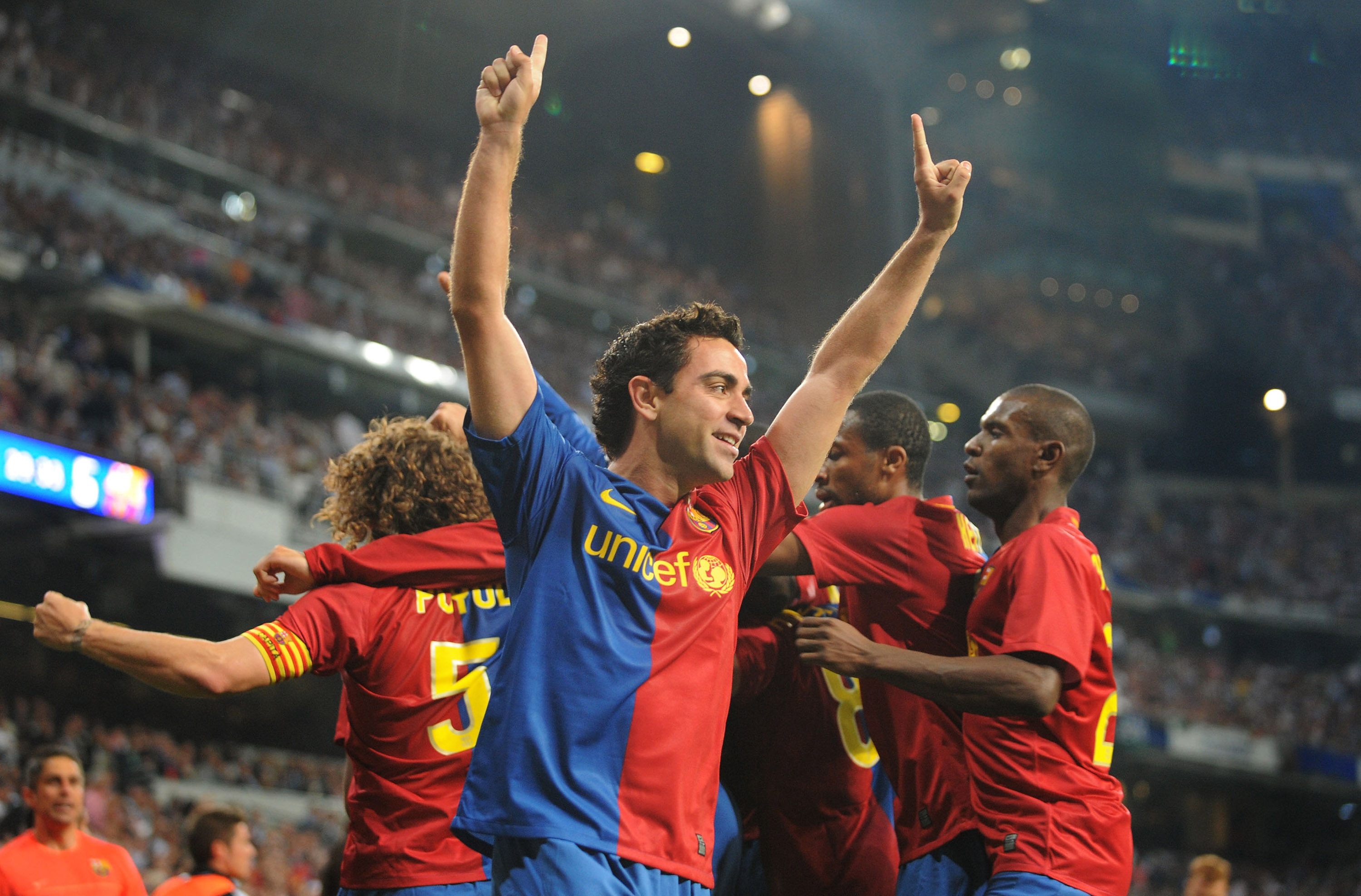  Xavi of Barcelona celebrates after Gerard Pique scored Barcelona's sixth goal against Real Madrid.