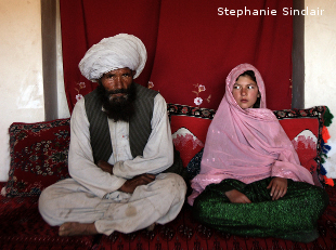 Faiz, 40, and Ghulam, 11, sit in her home prior to their wedding in the rural Afghnanistan on Sept. 11, 2005.  