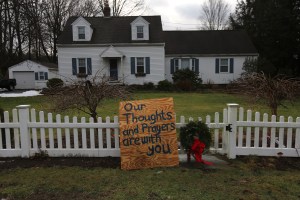  A sign leans against a home's picket fence near Sandy Hook Elementary School on January 14, 2013 in Newtown, Connecticut. (Photo credit: John Moore/Getty Images)