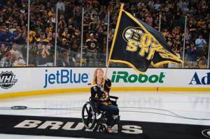 Adrianne Haslet-Davis waves a “Boston Strong” flag at a Bruins playoff game. Source: Getty
